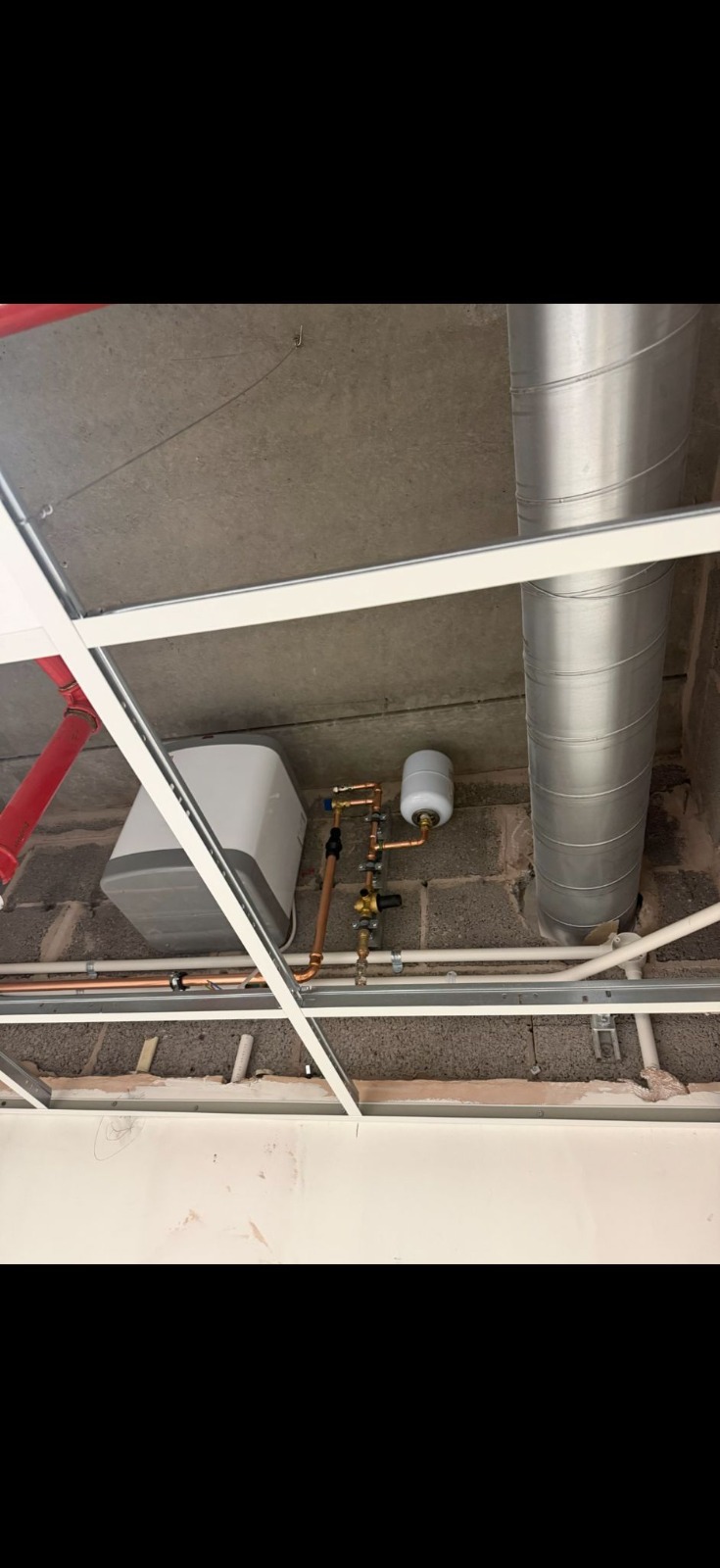 Commercial copper pipework and isolation valves above suspended ceiling