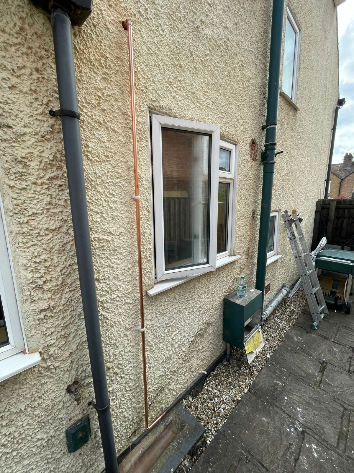 External copper gas pipework run to side of property