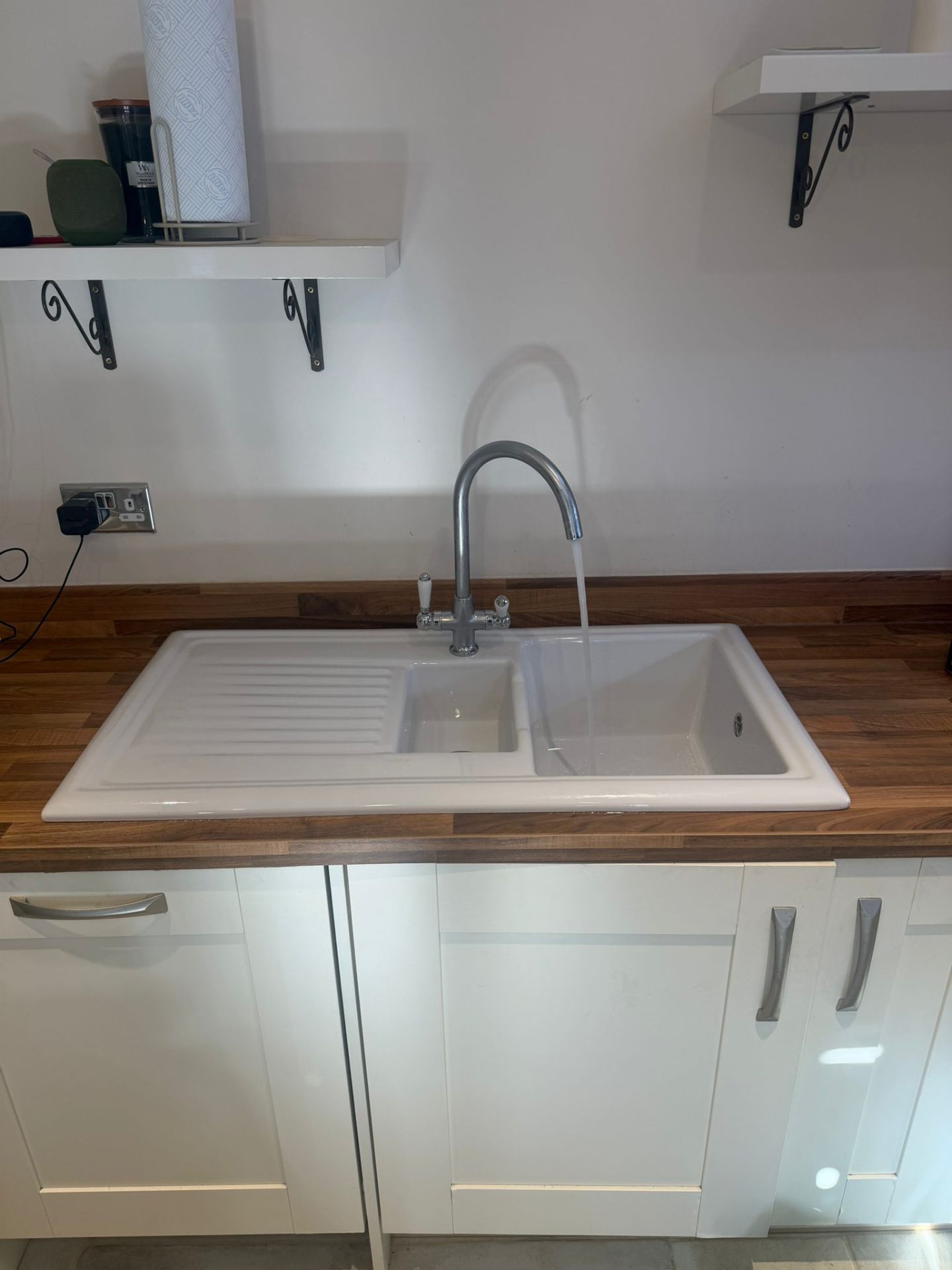 White ceramic 1.5 bowl kitchen sink with chrome monobloc mixer tap on walnut worktop