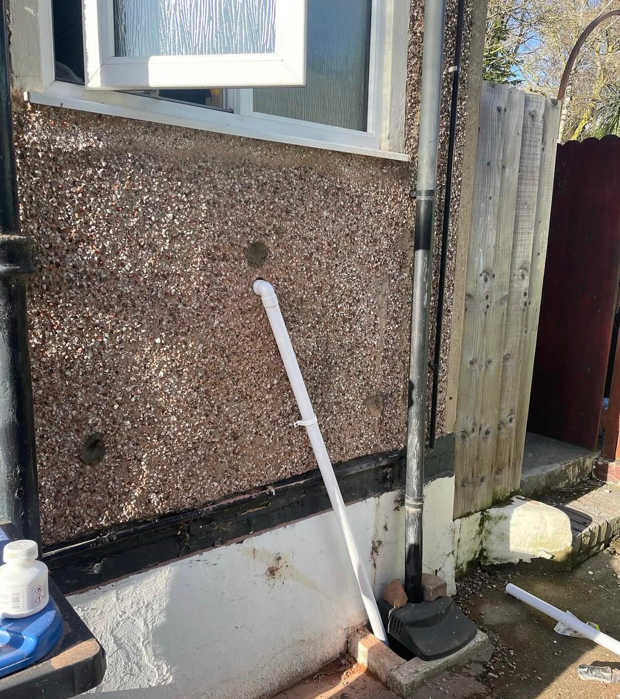 External soil and waste pipework on rendered exterior wall