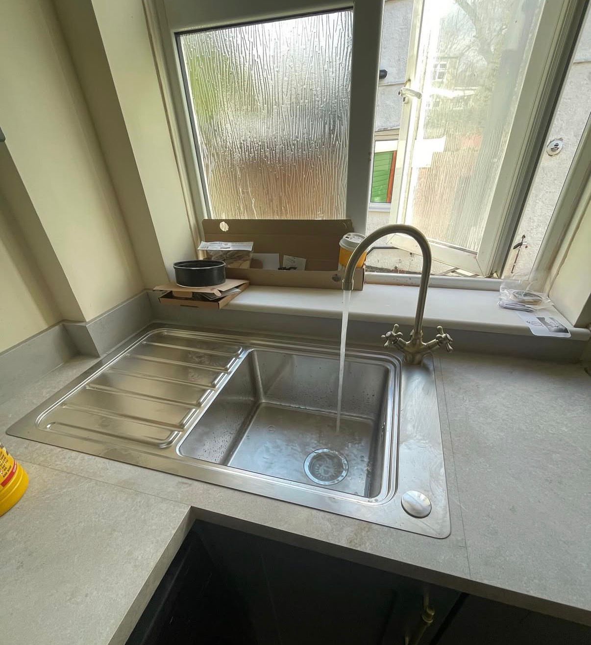 Kitchen sink installation with new mixer tap and worktop